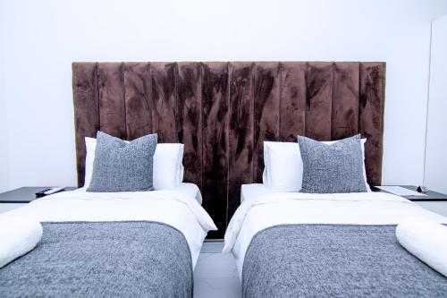 two beds sitting next to each other in a bedroom at Morning Mist Lodge in Livingstone