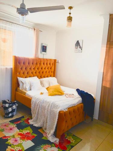 a bedroom with a large orange bed in a room at Softlife Home Classic Studio 2 in Mombasa
