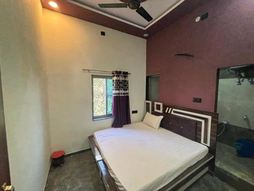 a bedroom with a bed with a ceiling fan at Yuvraj Guest house in Khātu