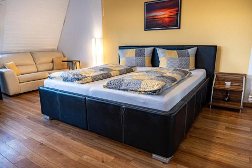 a large bed in a room with a couch at Ferienapartment Seeblick in Meersburg