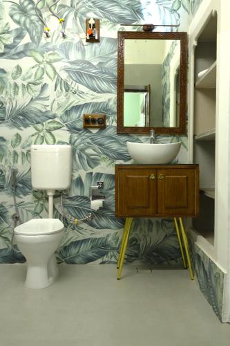 a bathroom with a sink and a toilet and a mirror at House of Amer in Jaipur