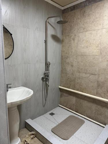 a bathroom with a shower with a toilet and a sink at DelLuna in Almaty