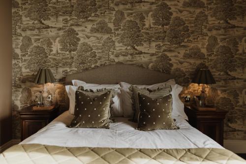 a bedroom with a large bed with pillows at Cartmel Old Grammar in Cartmel