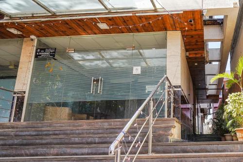 a building with a glass door and some stairs at FabHotel The Prime - Nr Horamavu in Bengaluru