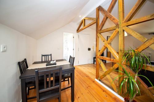 a dining room with a table and a wooden floor at Casa Moniz - 4 floor in Lisbon