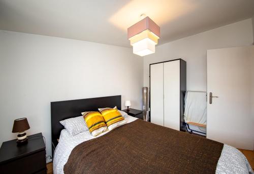 a bedroom with a large bed with yellow pillows at Casa Moniz - 4 floor in Lisbon
