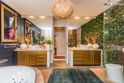 a bathroom with two sinks and a shower at Luxurious Hideaway Villa in Midrand