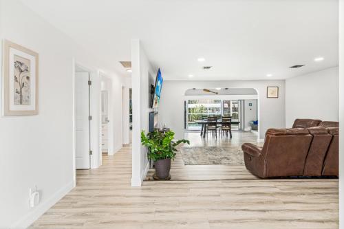 a living room with a couch and a chair at Gulf Breeze Haven Direct Gulf Access Pool+Dock in Cape Coral