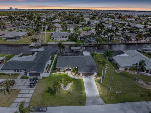 an aerial view of a house with palm trees at Gulf Breeze Haven Direct Gulf Access Pool+Dock in Cape Coral