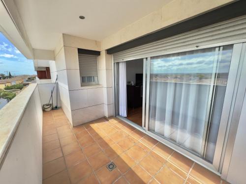 an empty balcony with a view of the ocean at ApartHome Domocenter in Bormujos