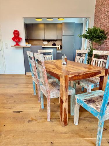 a wooden table and chairs in a kitchen at Modern 6 bathroom villa in the city in Oldenburg