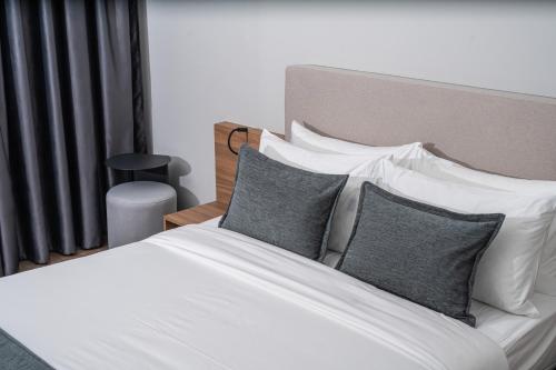 a bedroom with a bed with white sheets and pillows at Valbona Resort & Spa in Valbonë