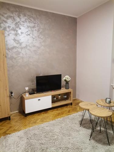 a living room with a flat screen tv on a cabinet at Apartman petrov 1 in Pančevo