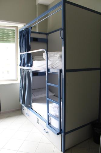 two bunk beds in a room with a window at Roma Scout Center in Rome