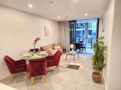 a living room with a table and a couch at Free Car Park, Infinity Pool, City View, Spa-Sauna in Brisbane