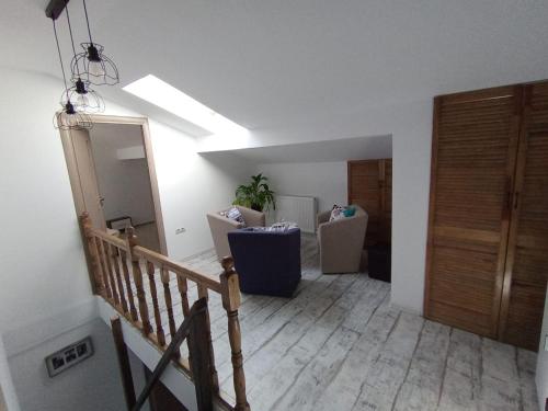 a living room with a skylight and a hallway with a staircase at La Maia Acasă - Refugiul boem in Sibiu