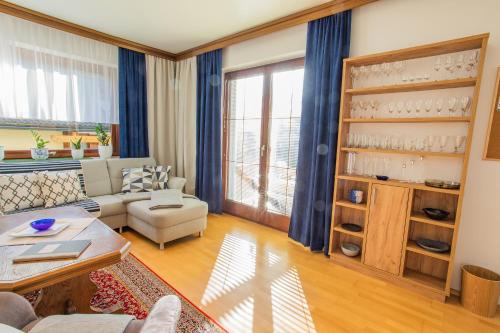 a living room with a couch and a table at Landhaus Seraphine - by myNests in Assachberg