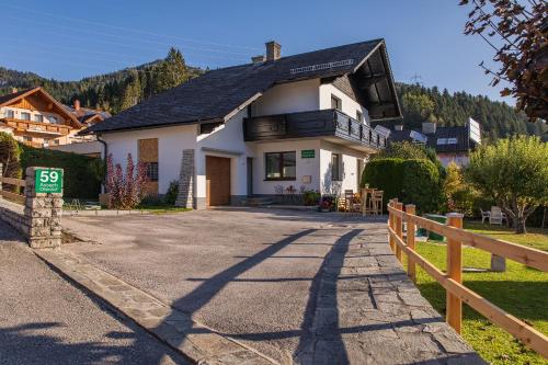a white house with a fence in front of it at Landhaus Seraphine - by myNests in Assachberg