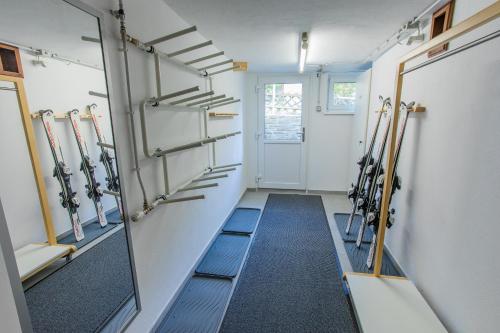 a dressing room with ski equipment on the wall at Landhaus Seraphine - by myNests in Assachberg