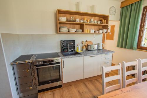 a kitchen with a stove and a counter top at Landhaus Seraphine - by myNests in Assachberg