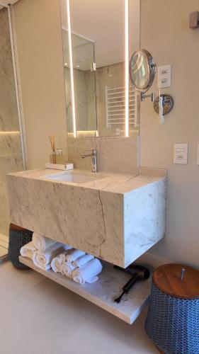 a bathroom with a sink and a mirror at île de Pipa - Ma Plage Hotel in Pipa
