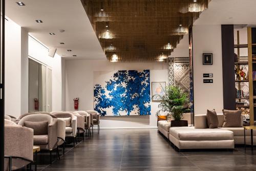 a waiting room with chairs and a painting on the wall at Valbona Resort & Spa in Valbonë