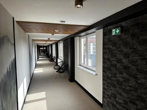 a hallway of a building with a sign on the wall at WRZOS resort & wellness in Węgierska Górka