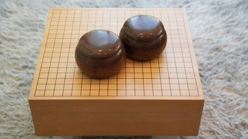 two brown objects are sitting on a piece of wood at Beachside base KURUWA in Yokosuka