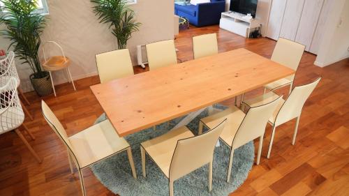 a wooden table and chairs in a living room at Beachside base KURUWA in Yokosuka