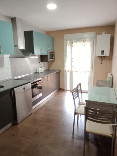 a kitchen with a table and chairs and a counter top at El Vergel del Piedra in Munébrega