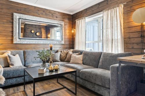 a living room with a couch and a table at Nice apartment with Sauna and ski in out Trysil in Trysil
