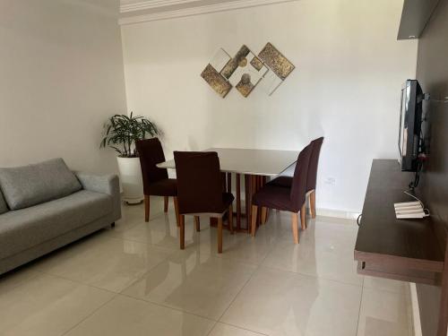 a living room with a table and chairs and a couch at Casa em Barueri in Barueri