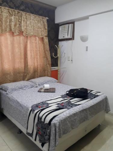 a bedroom with a bed with a towel on it at Studio Centro Floripa 05 in Florianópolis