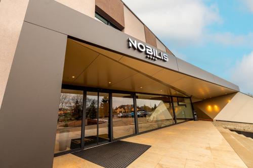 a building with a nordisk sign on the side of it at Hotel NOBILIS - Mladá Boleslav in Bradlec