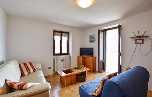 a living room with a couch and a tv at Casa Meno in Novate Mezzola