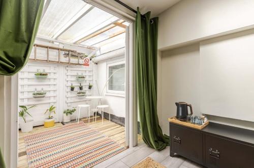 a room with a glass door and a room with plants at Madeira Guest House in Brighton & Hove