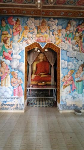 a room with a painting on the wall of a room with aoint at RKO Villa27 - Unawatuna in Habaraduwa