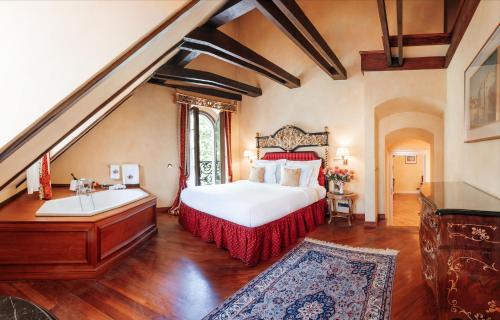 a bedroom with a bed and a sink and a tub at Alchymist Grand Hotel and Spa - Preferred Hotels & Resorts in Prague