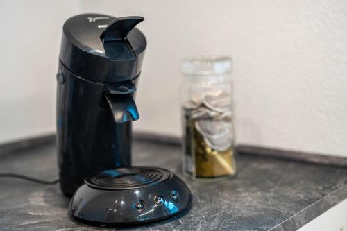 a coffee maker and a glass jar on a counter at Ferienwohnung im Grünen in Oppenau