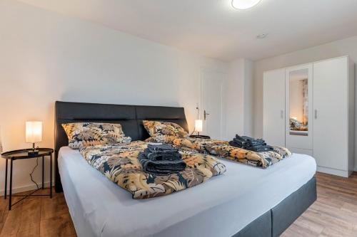 a bedroom with a large bed with a bedspread and pillows at Ferienwohnung im Grünen in Oppenau