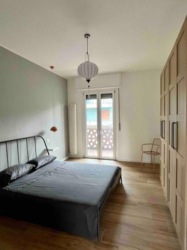a bedroom with a bed and a large window at Milano Fair Apartment in Pero