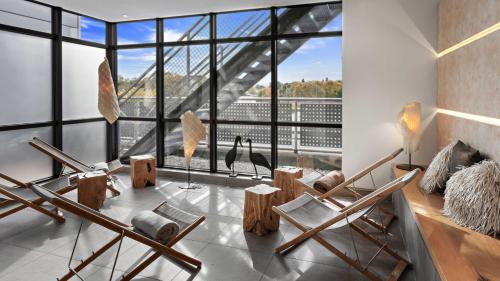 a living room with chairs and a large window at Hotel Central in Hof