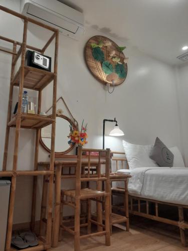 a room with a bed and a table and chairs at Tâm Homestay in Hue