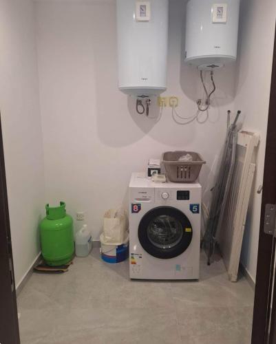 a laundry room with a washing machine in the corner at Happy stay 1 in Marsaxlokk
