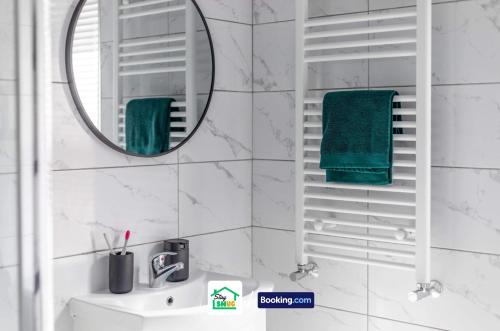 a white bathroom with a mirror and a sink at Four Bedroom House in Preston Perfect for Contractors in Preston