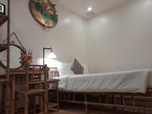 a bedroom with a bed and a clock on the wall at Tâm Homestay in Hue