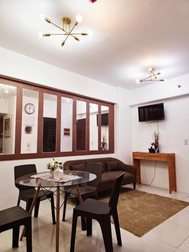 a living room with a table and chairs and a couch at V- 2 BR Unit in Baguio
