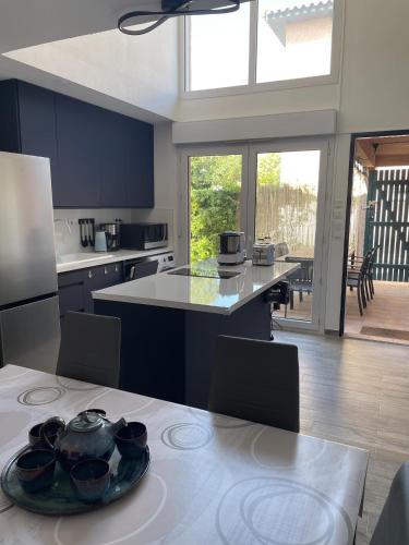 une cuisine avec une table et une cuisine avec vue dans l'établissement St Cyprien Superbe maison residence avec piscine, à Saint-Cyprien