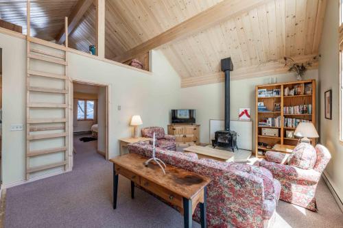 a living room with a couch and a table at Bray House - Ski-in Ski-out family home in Teton Village