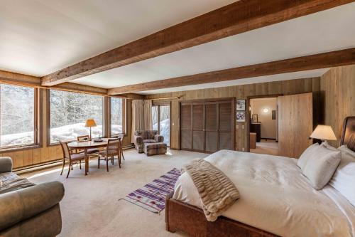a bedroom with a large bed and a dining room at Bray House - Ski-in Ski-out family home in Teton Village